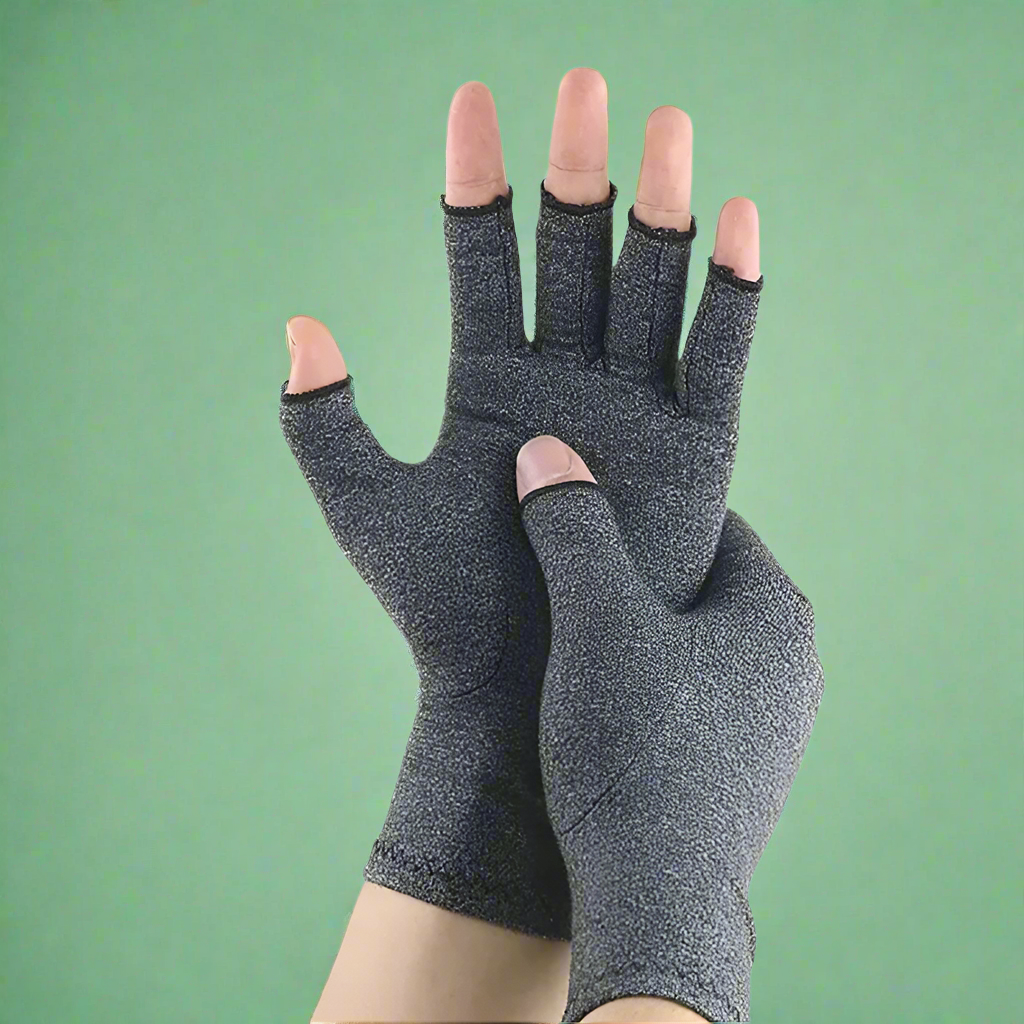 Pair of gray compression gloves on a green background